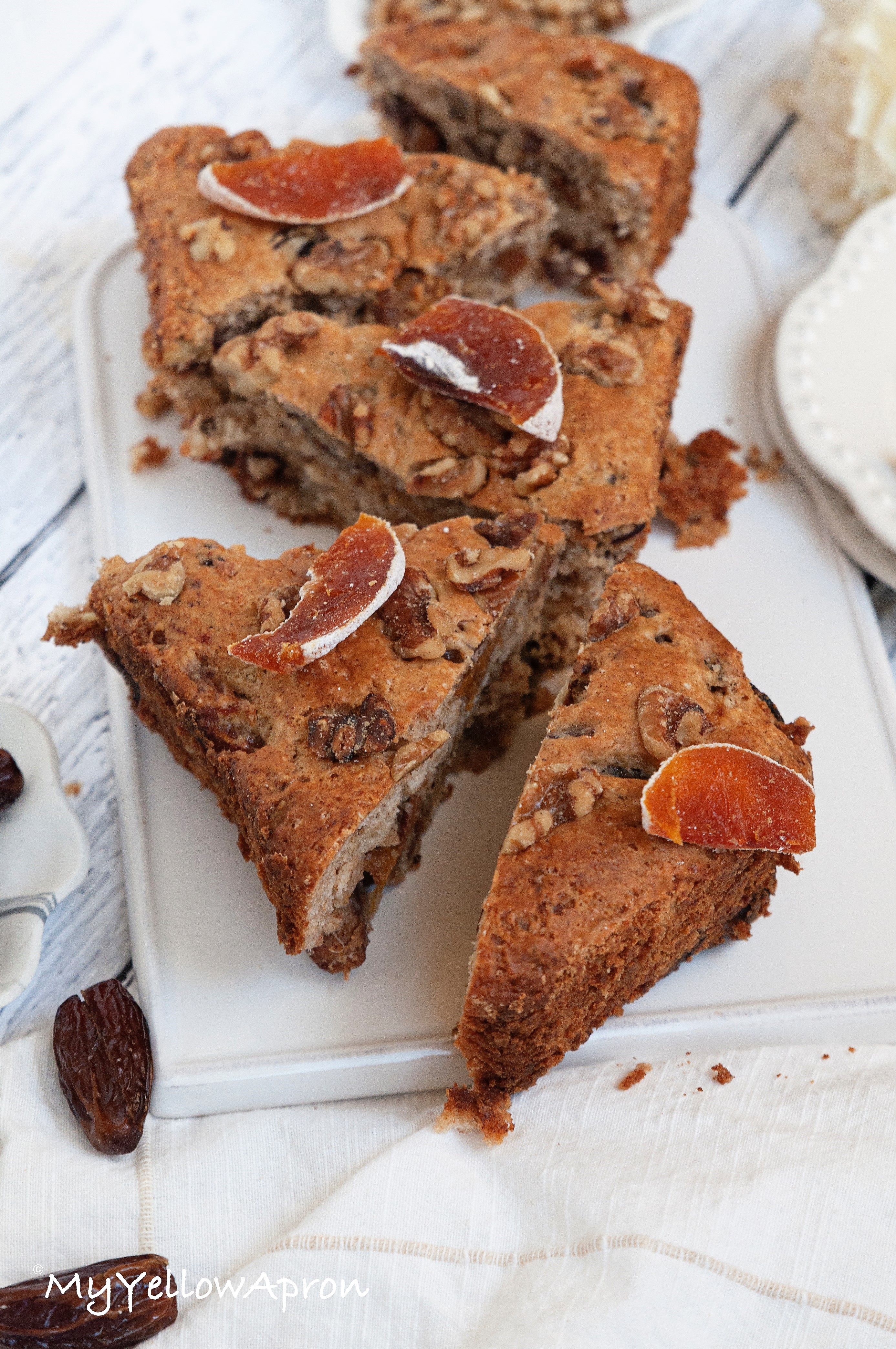 This eggless date and persimmon coffee cake is an one-bowl, rich and dense cake filled with sweet persimmon bites, chopped dates topped, and topped with walnuts.